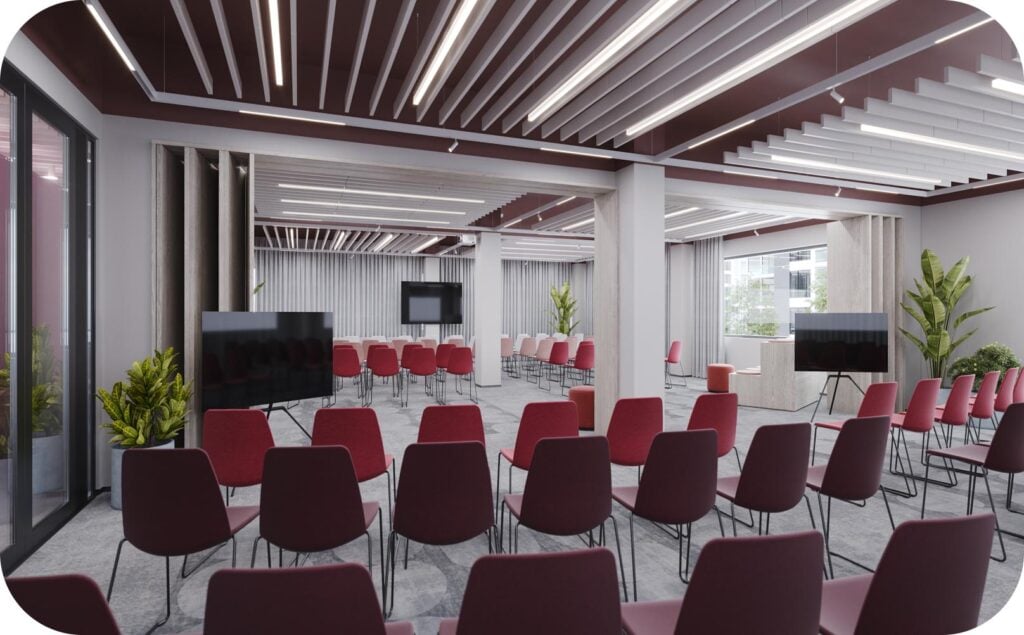 Modern conference room with red chairs and screens.