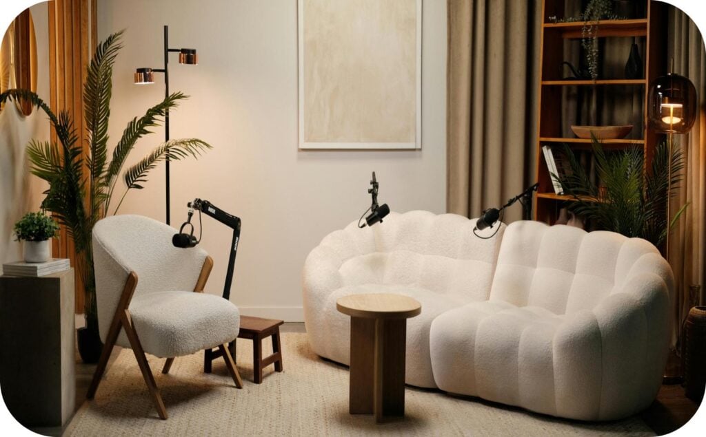 Cozy podcast studio with microphones and seating