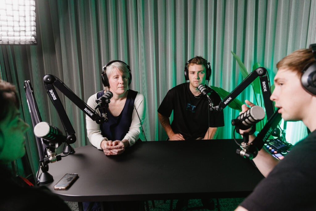 People recording podcast in a studio setting.