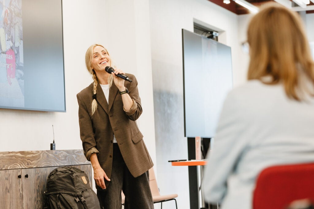 Woman speaking into microphone during presentation.