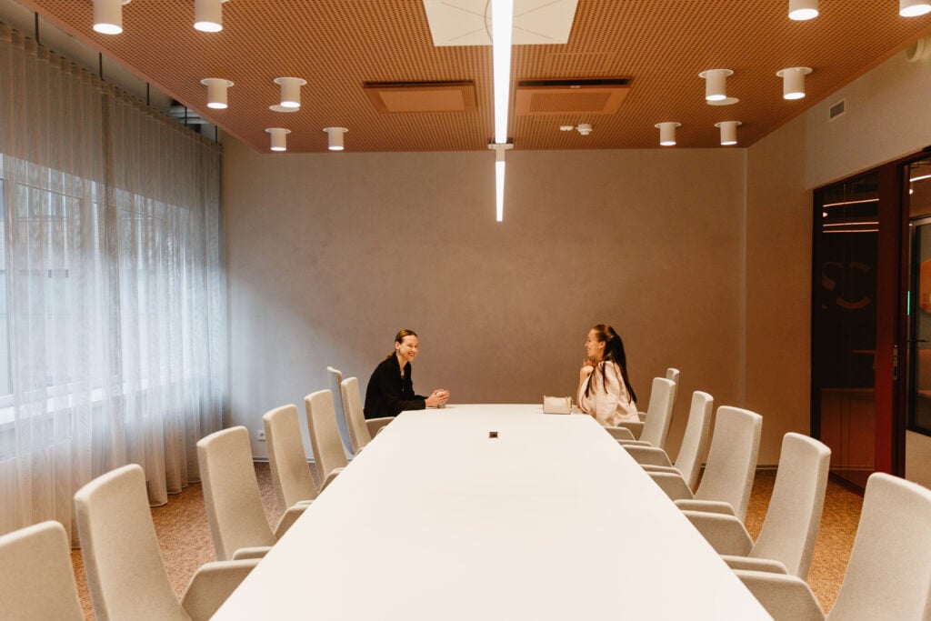 Two people talking in a conference room