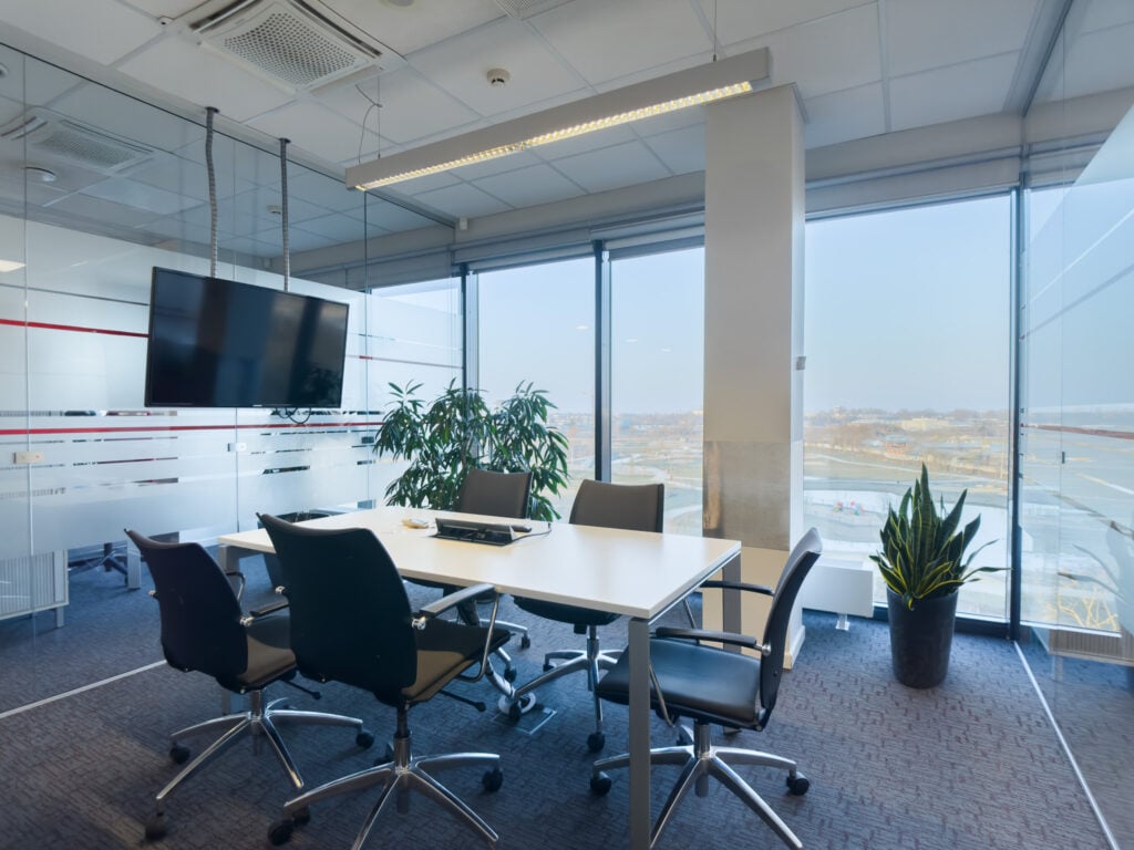 Modern conference room with view and TV screen.