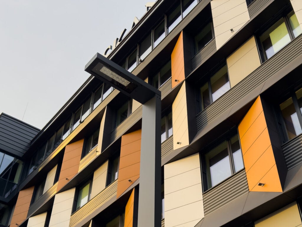 Modern building with colorful geometric facade panels.