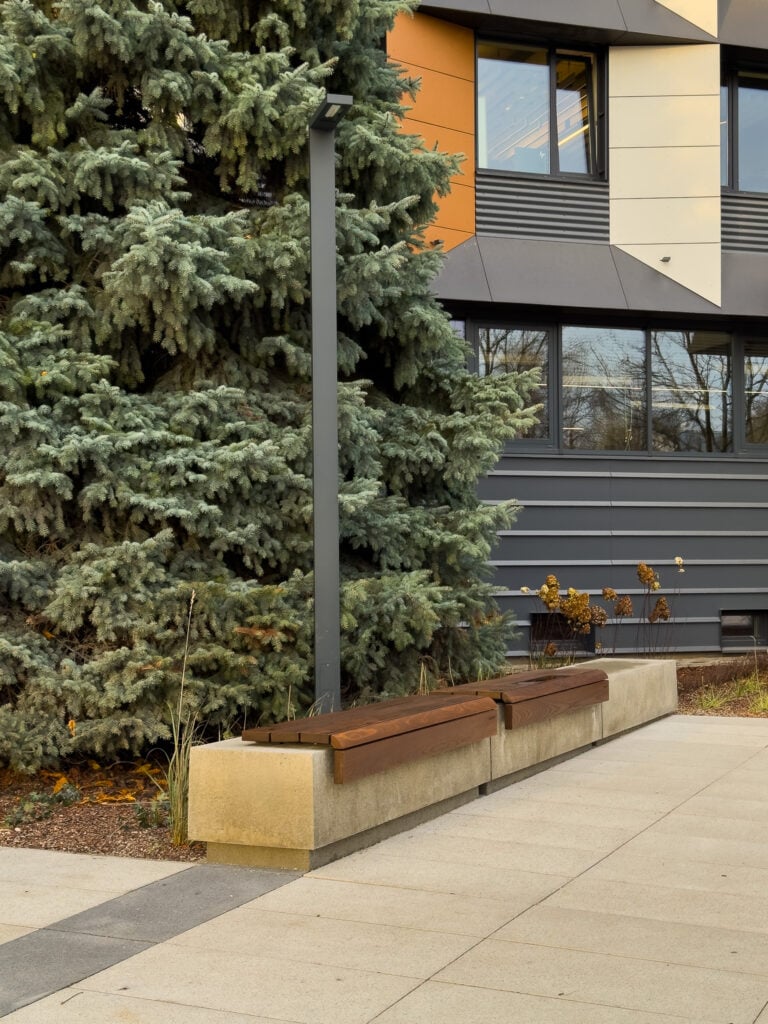 Quiet courtyard with bench near modern building.