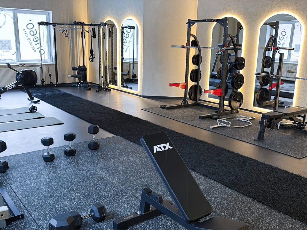 Modern gym with various workout equipment.