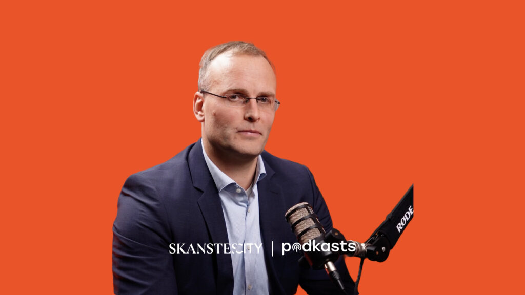 Man in suit speaking into microphone