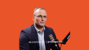 Man in suit speaking into microphone