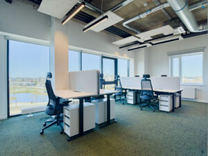 Modern open office with desks and large windows
