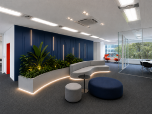 Modern office lounge with curved sofa and plants