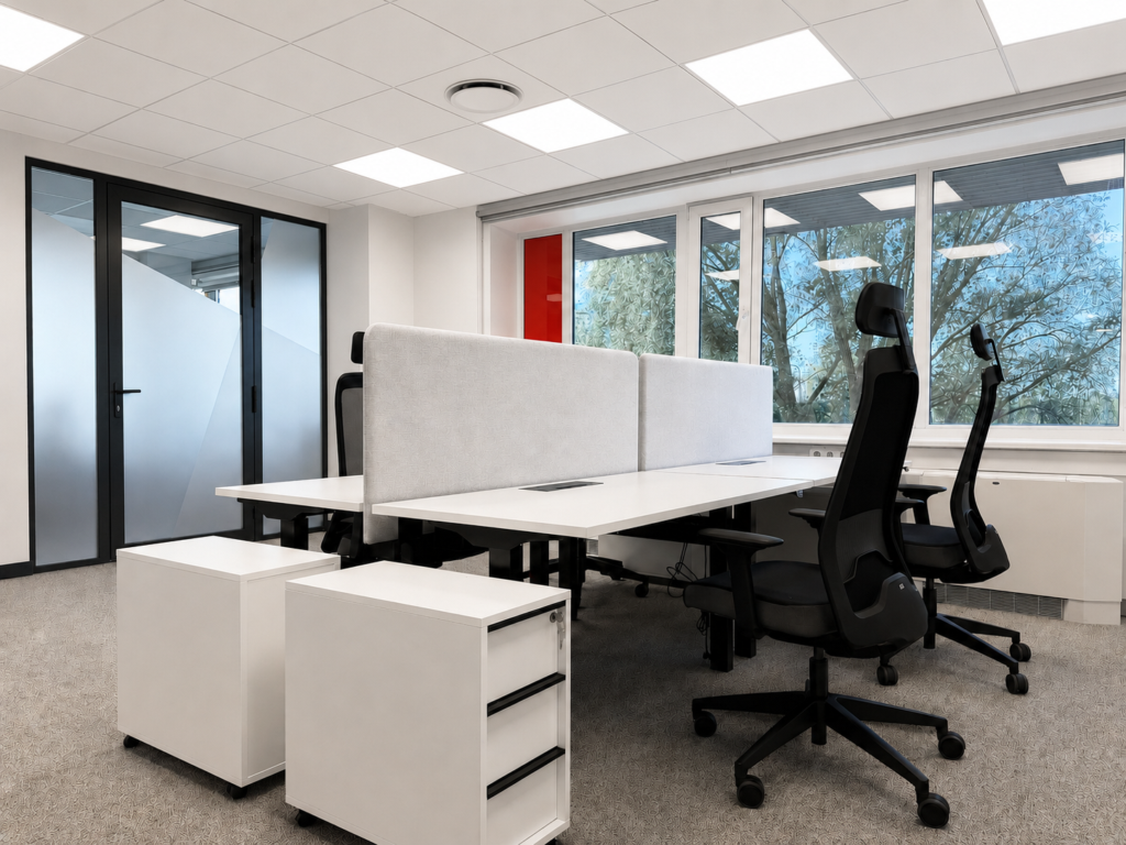 Modern office workspace with desks, chairs, and large windows
