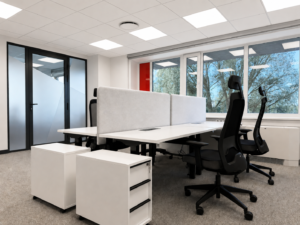 Modern office workspace with desks, chairs, and large windows