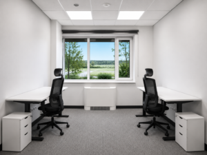 Bright two-person office with desks and large window